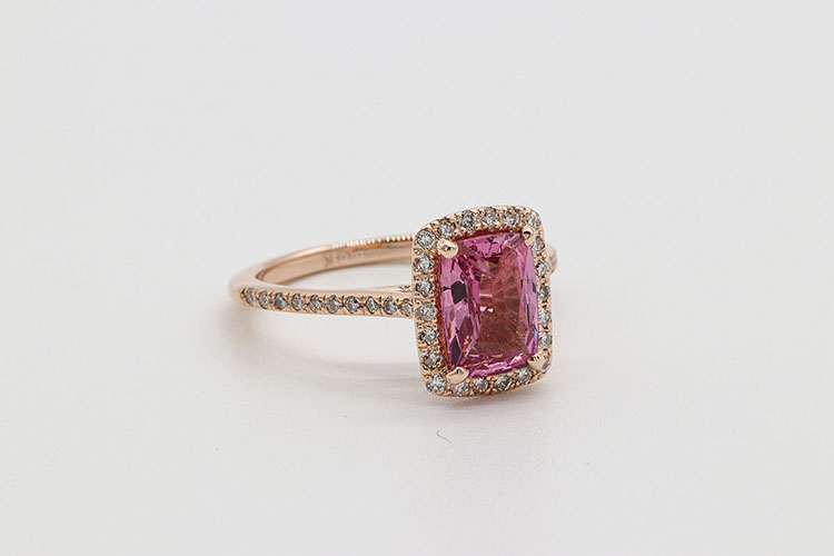 a gold woman ring with pink stone