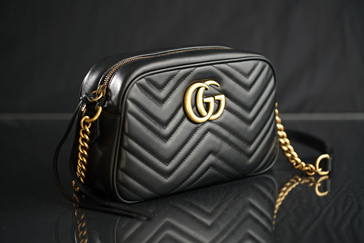 a black women purse with gold color bands